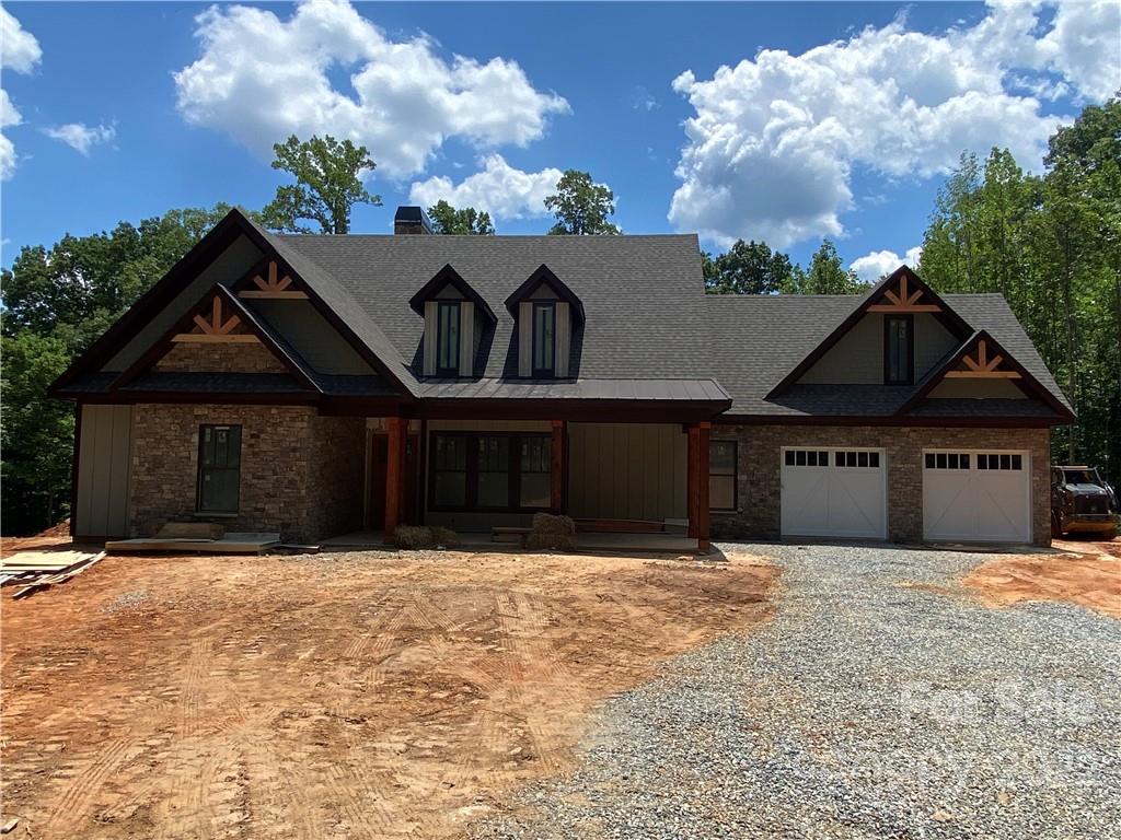 42 Alexander Ridge Way Mill Spring, Unit 118 Mill Spring, NC 28756 - Photo 1 of 35 a front view of a house with a yard