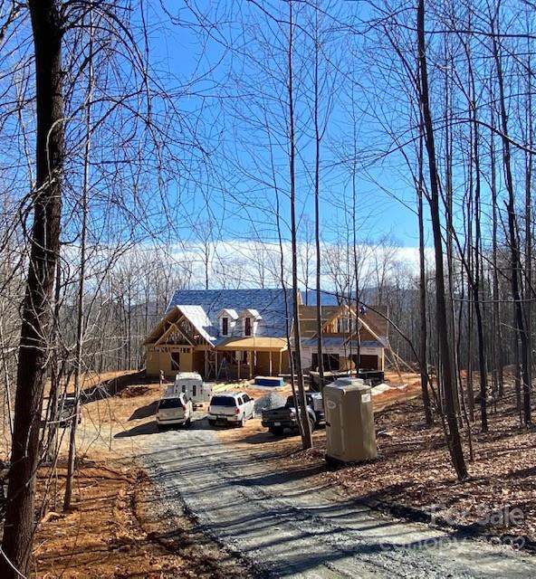 42 Alexander Ridge Way Mill Spring, Unit 118 Mill Spring, NC 28756 - Photo 5 of 35 a view of a patio with a table chairs and wooden fence