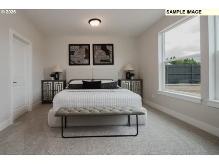 a bedroom with a bed a table and painting