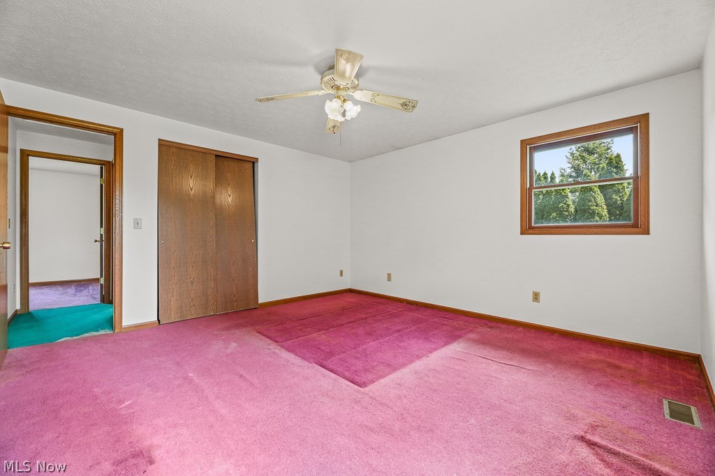 2642 Blake Road Wadsworth, OH 44281 - Photo 19 of 46 Bright interior room featuring a window with exterior tree views, a ceiling fan, and sliding closet doors