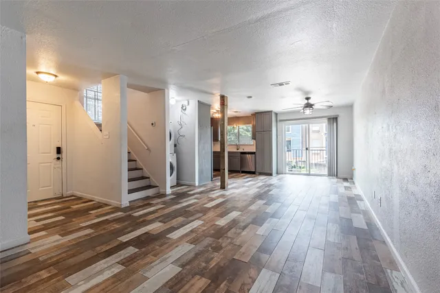 a view of empty room with wooden floor and fireplace