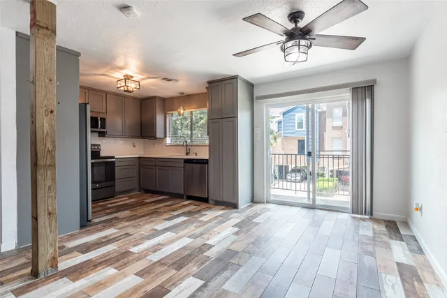 a view of a room with wooden floor
