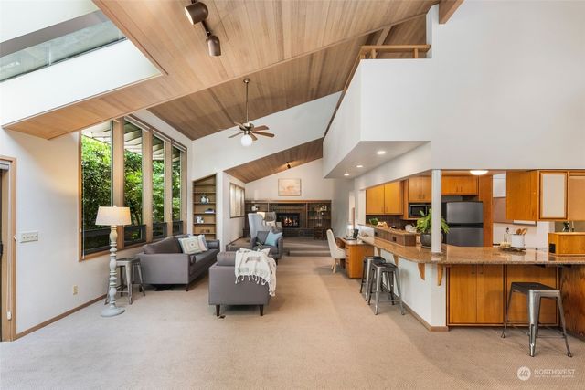 a dining room with wooden floor and large window