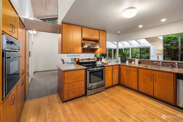 a dining room with furniture a chandelier and wooden floor