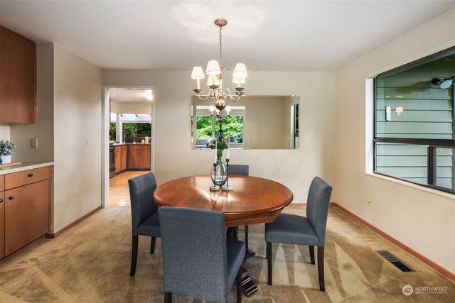a living room with furniture a window and a potted plant