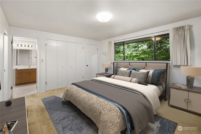 a bedroom with a bed table and a window