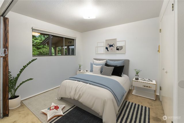 a bathroom with a sink a toilet a mirror and shower