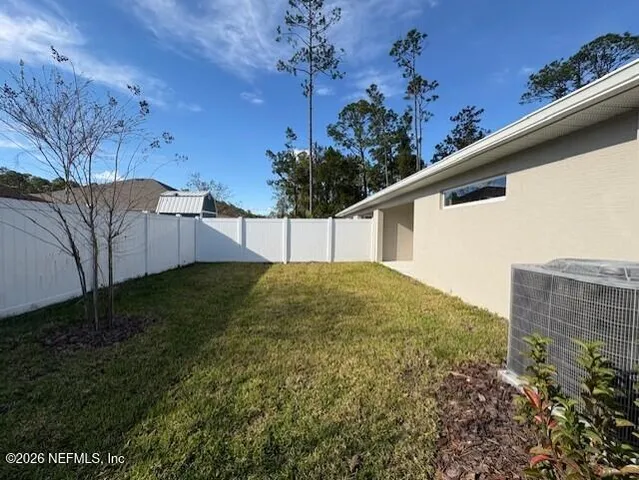 a backyard of a house with lots of green space
