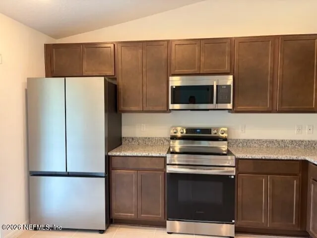 a kitchen with cabinets and steel stainless steel appliances