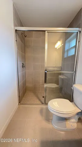 a bathroom with a toilet and a shower