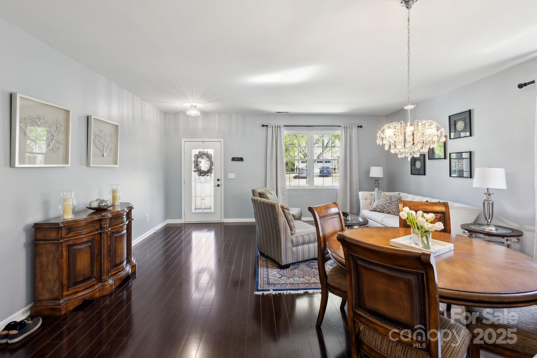 221 Sycamore Creek Road Fort Mill, SC 29708 - Photo 11 of 37 a view of a dining room with furniture a chandelier and wooden floor
