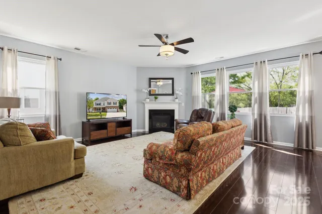 a living room with furniture a window and a fireplace