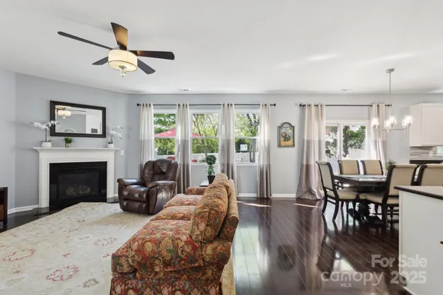 a living room with furniture fireplace and window