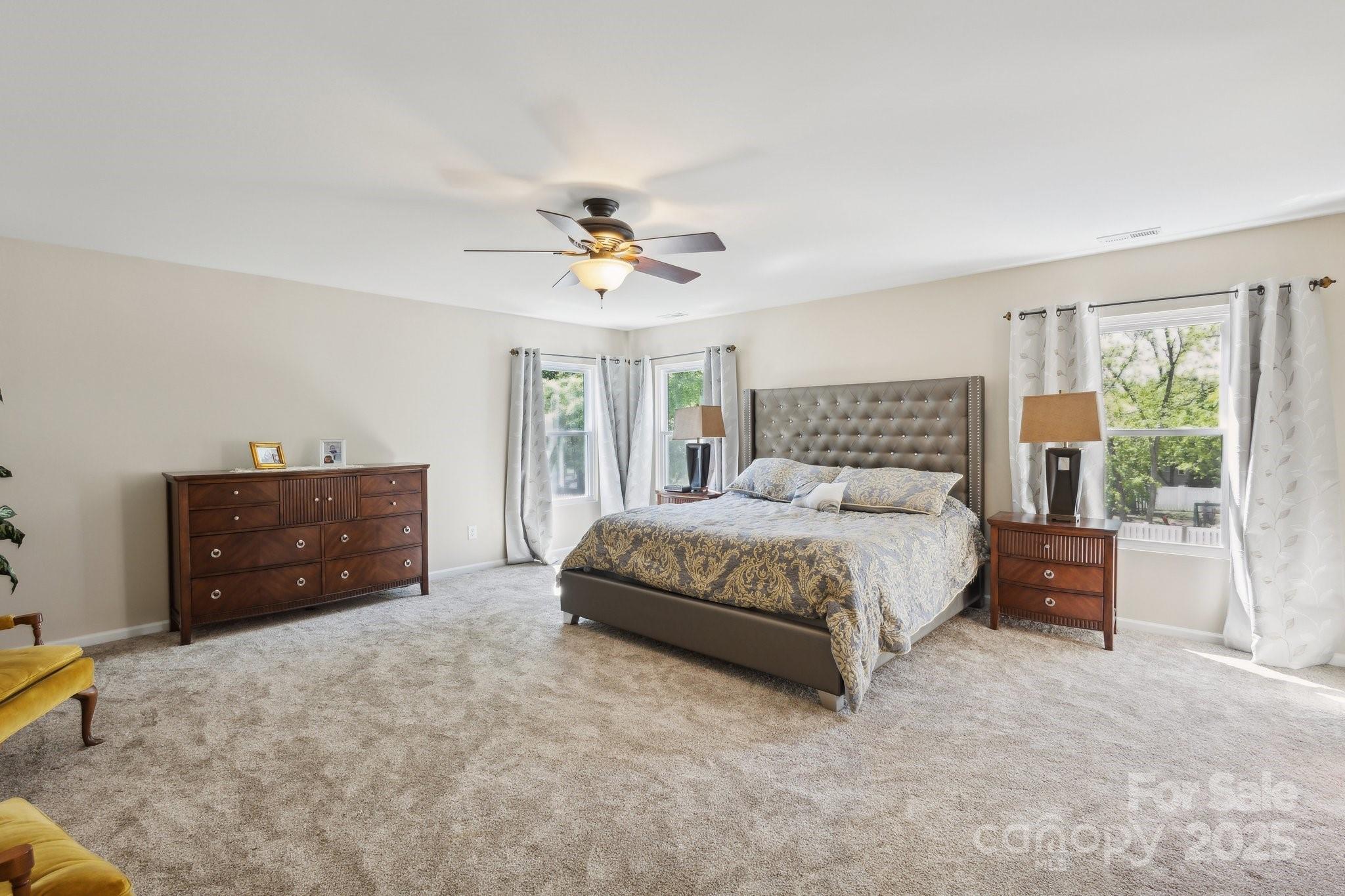 221 Sycamore Creek Road Fort Mill, SC 29708 - Photo 20 of 37 a spacious bedroom with a bed and a ceiling fan