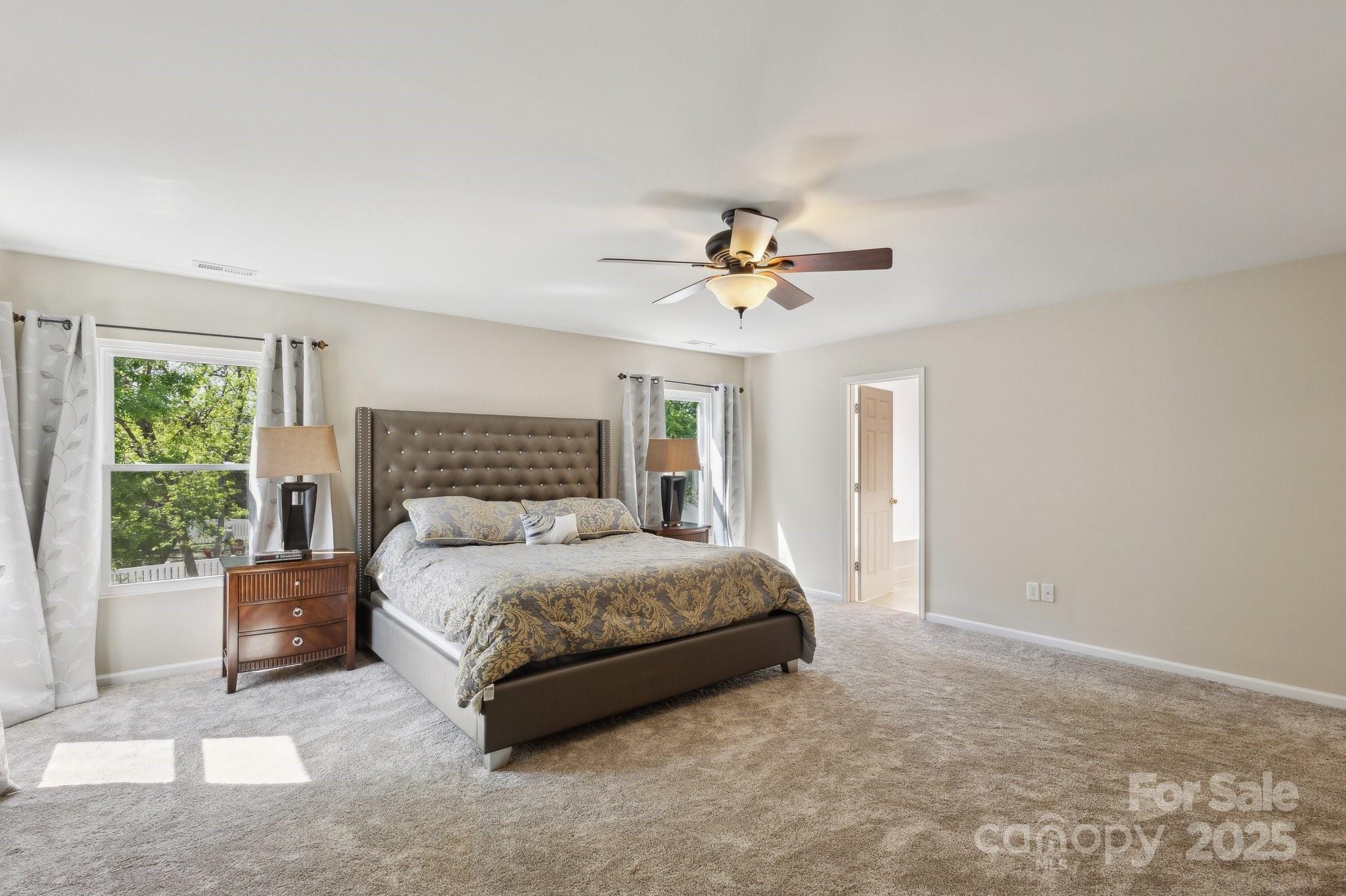 221 Sycamore Creek Road Fort Mill, SC 29708 - Photo 21 of 37 a bedroom with a bed and a chandelier