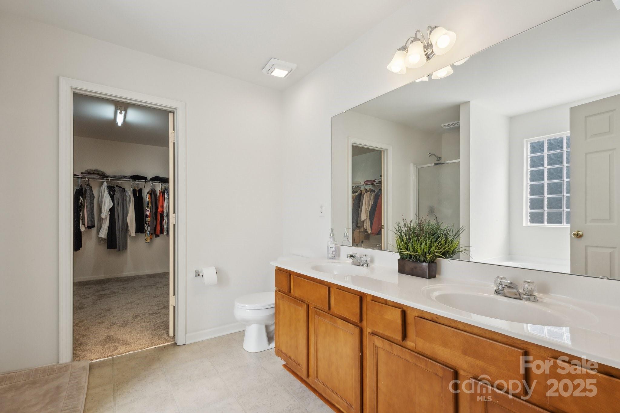 221 Sycamore Creek Road Fort Mill, SC 29708 - Photo 22 of 37 a spacious bathroom with a granite countertop sink a mirror and a shower