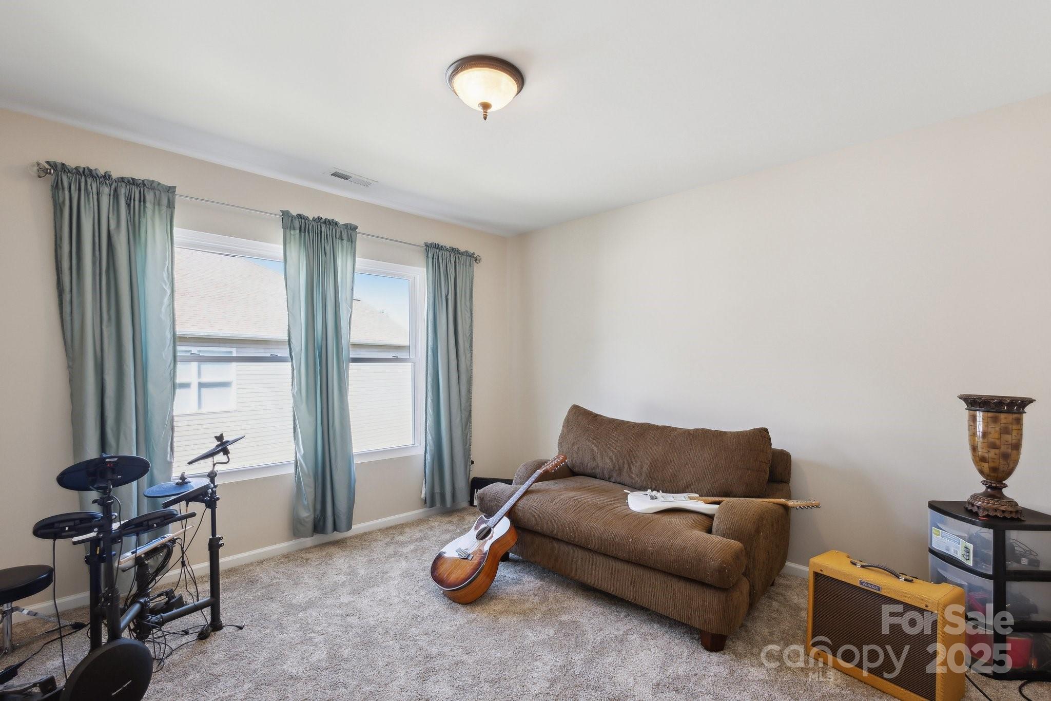 221 Sycamore Creek Road Fort Mill, SC 29708 - Photo 26 of 37 a living room with furniture a window and a flat screen tv