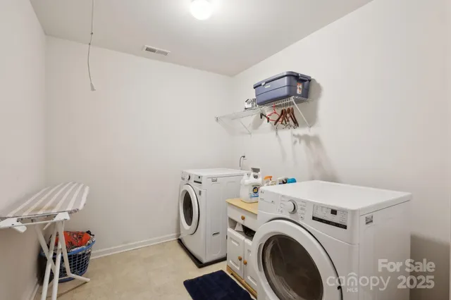 a view of storage and utility room with washer and dryer