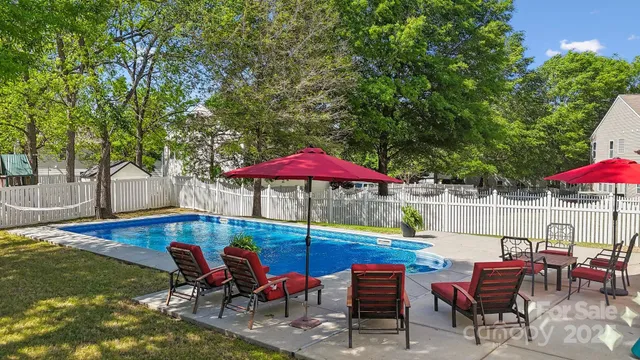 an outdoor sitting area with furniture and umbrella