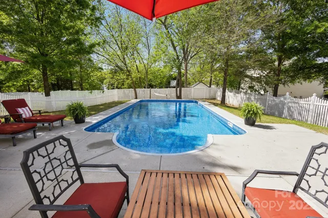 swimming pool view with a seating space