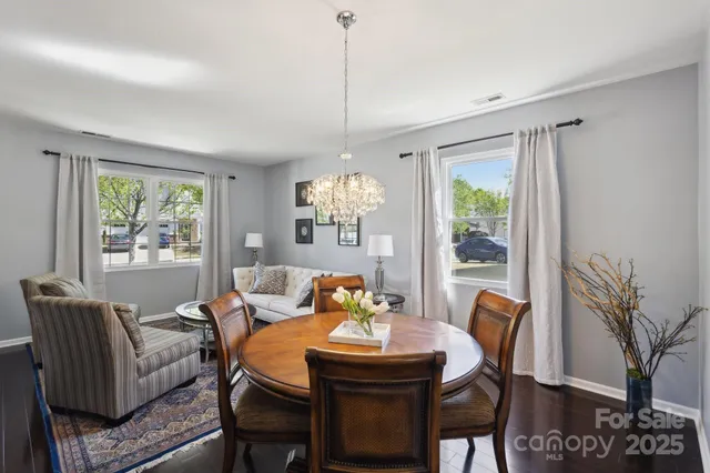 a dining room with furniture a chandelier and window