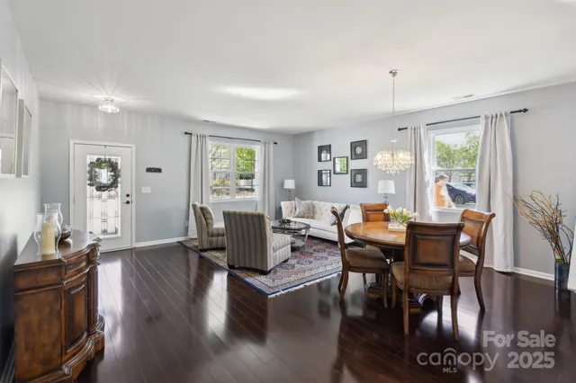 a living room with fireplace furniture and a wooden floor