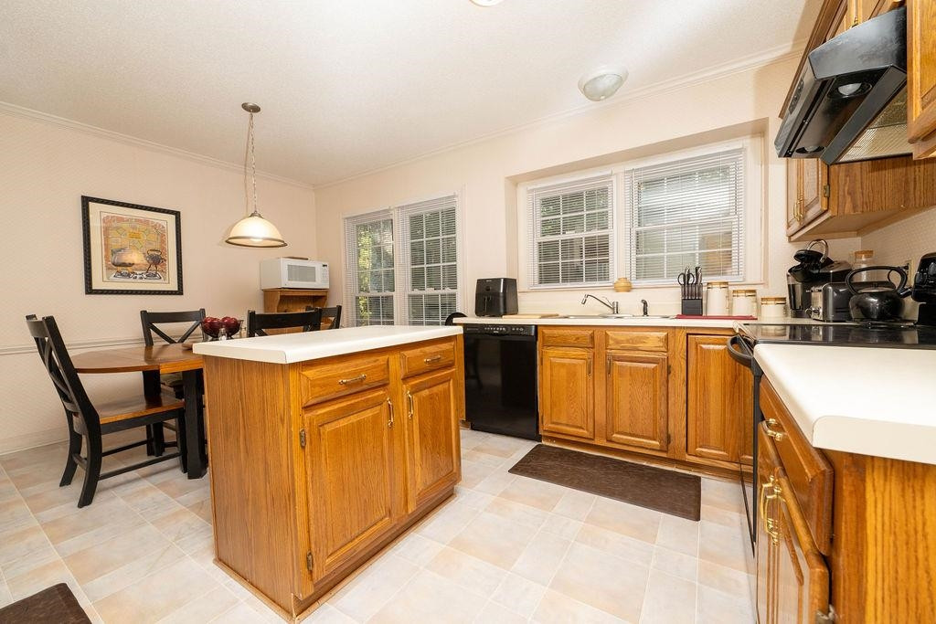 119 Nuttree Way Durham, NC 27713 - Photo 13 of 41 a kitchen that has a sink a stove and chairs