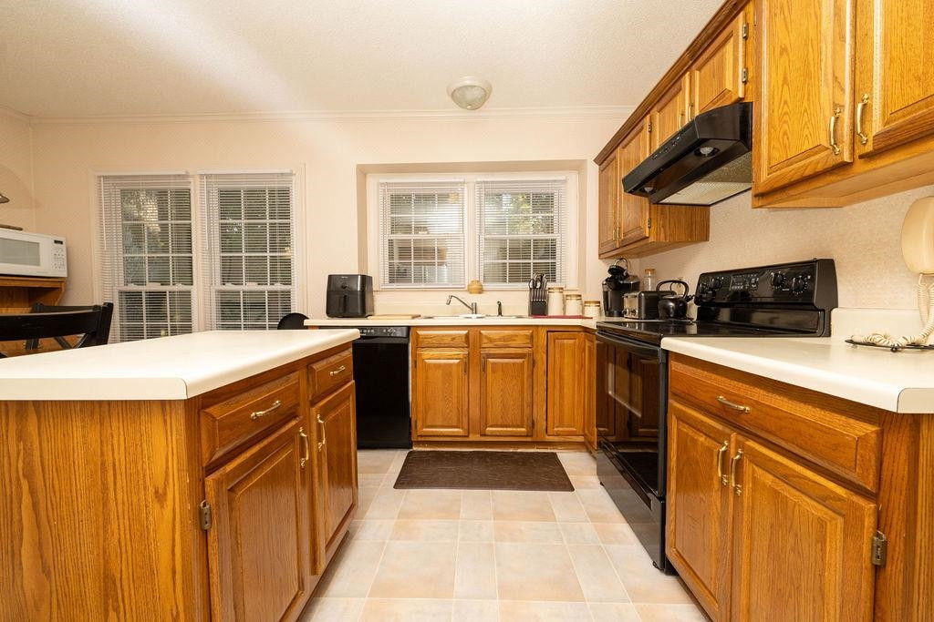 119 Nuttree Way Durham, NC 27713 - Photo 14 of 41 a kitchen with stainless steel appliances a sink stove and cabinets
