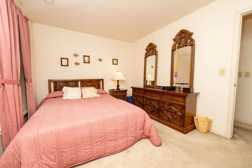 119 Nuttree Way Durham, NC 27713 - Photo 26 of 41 a bedroom with a bed and a night stand