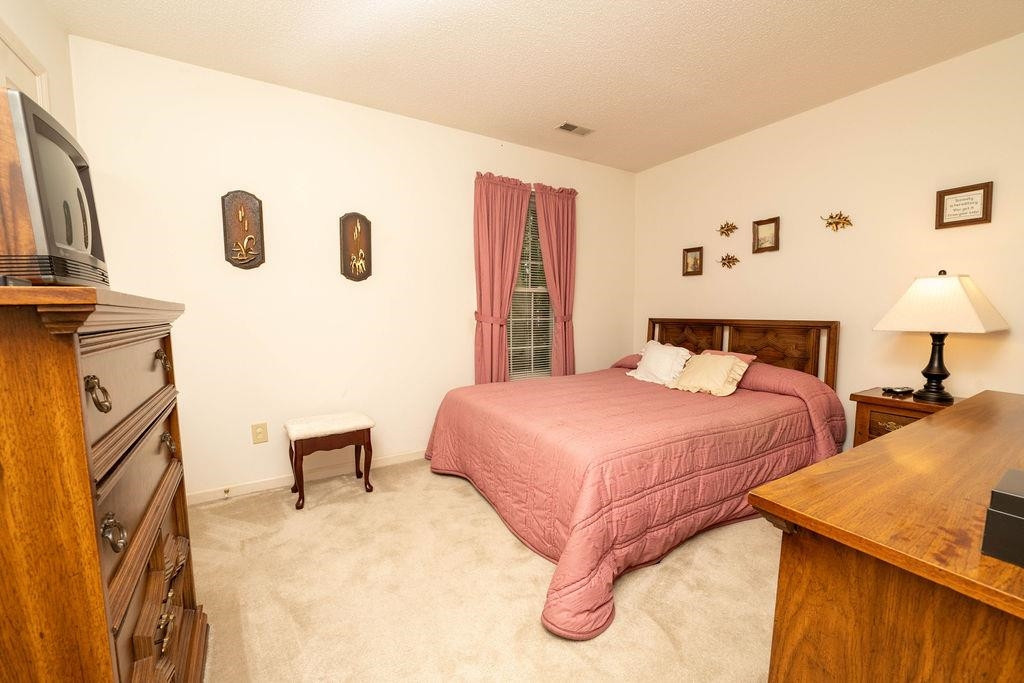 119 Nuttree Way Durham, NC 27713 - Photo 27 of 41 a bedroom with a bed and a lamp with window