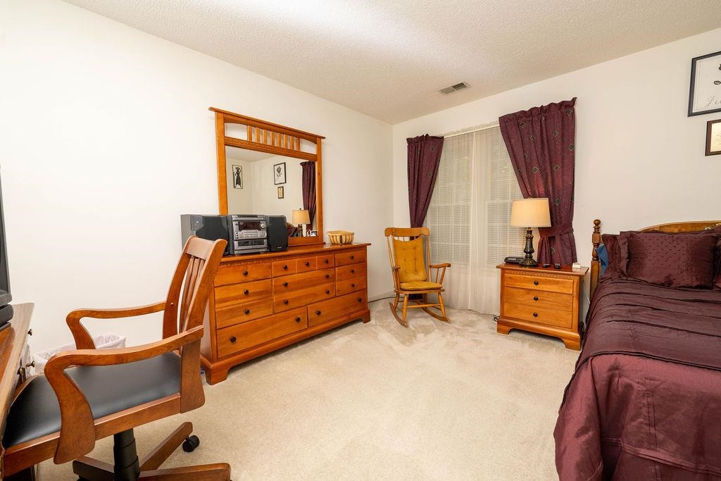 119 Nuttree Way Durham, NC 27713 - Photo 28 of 41 a bedroom with furniture and a window