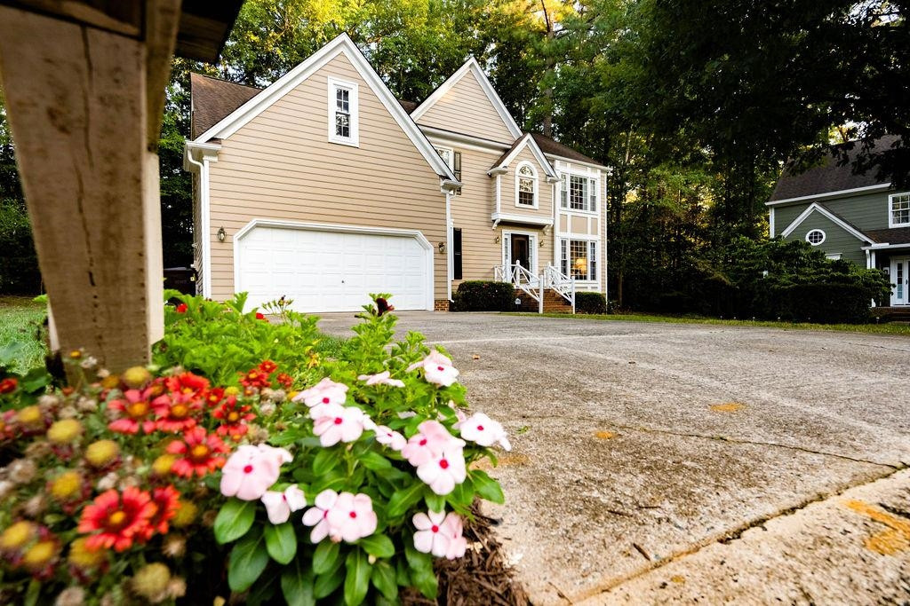 119 Nuttree Way Durham, NC 27713 - Photo 3 of 41 a front view of a house with a yard and flowers