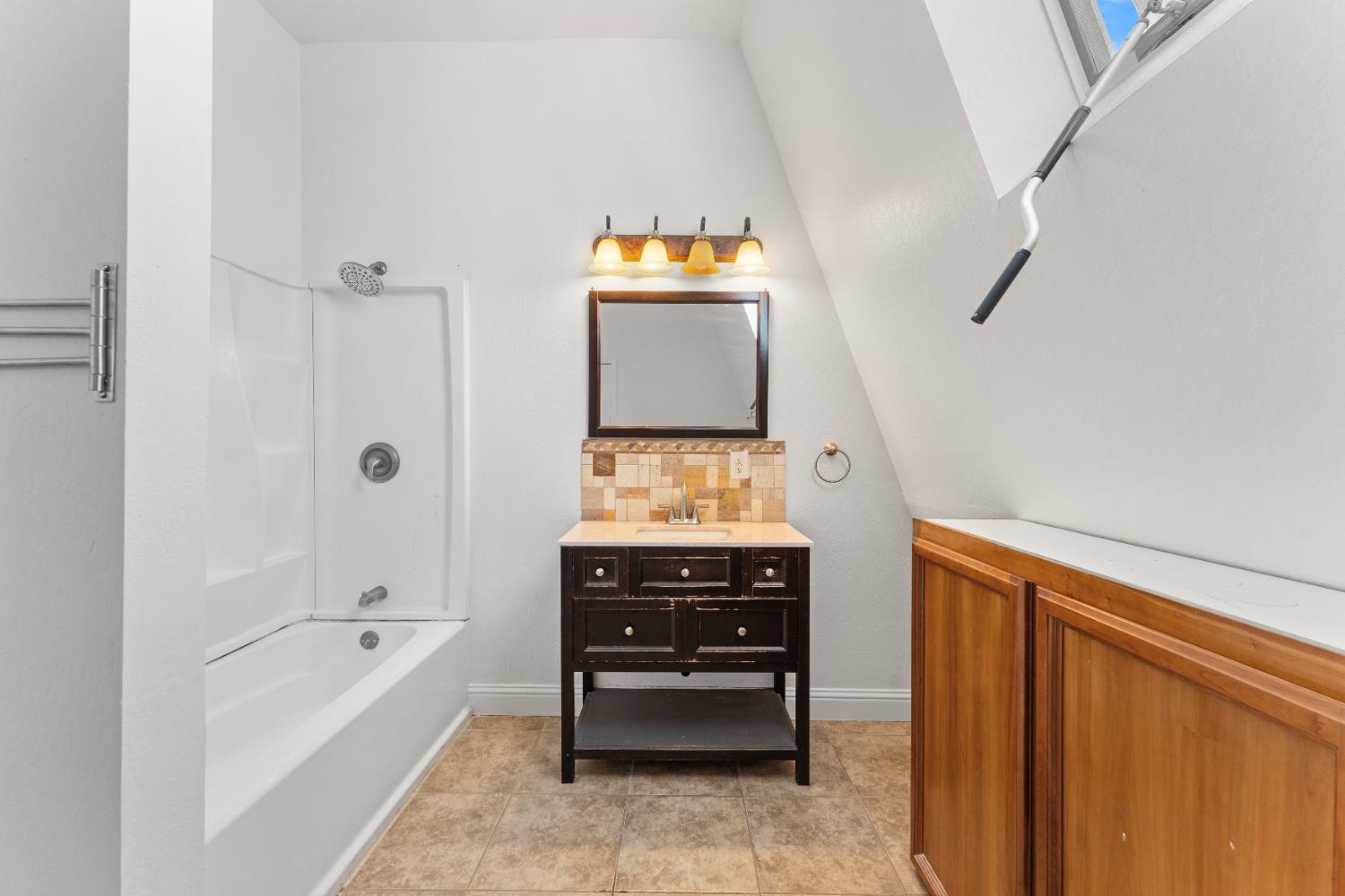 5585 Garden Bar Road, Unit 2 Lincoln, CA 95648 - Photo 21 of 65 a bathroom with a tub a sink and a window