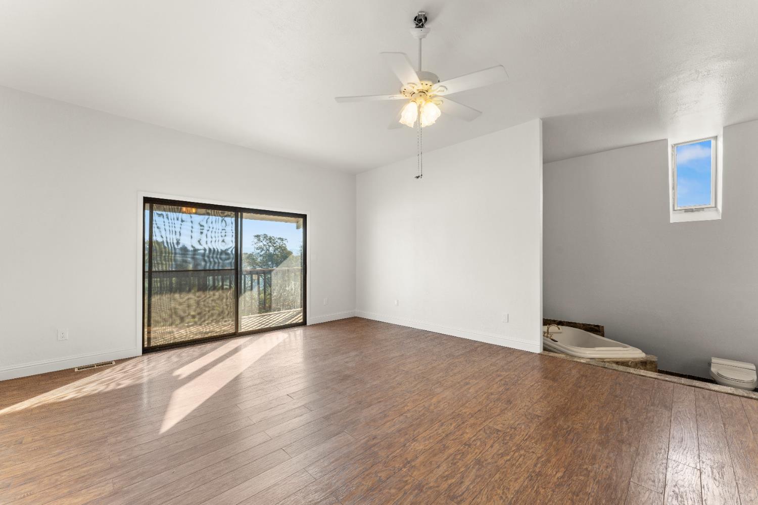 5585 Garden Bar Road, Unit 2 Lincoln, CA 95648 - Photo 24 of 65 a view of an empty room with wooden floor and fan
