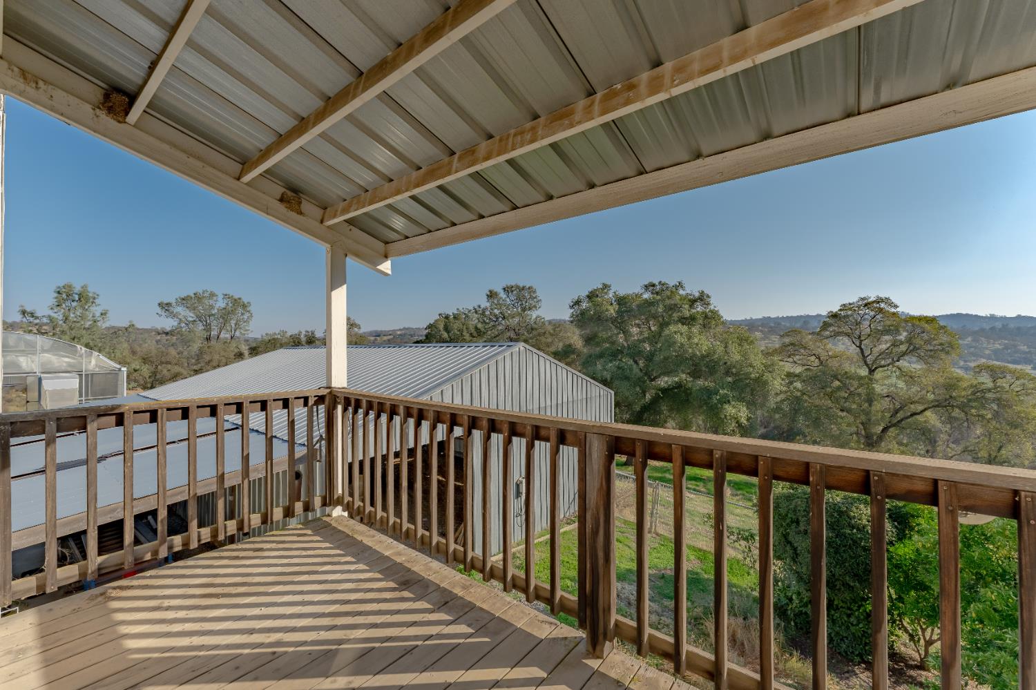 5585 Garden Bar Road, Unit 2 Lincoln, CA 95648 - Photo 32 of 65 a balcony with wooden floor in front of it