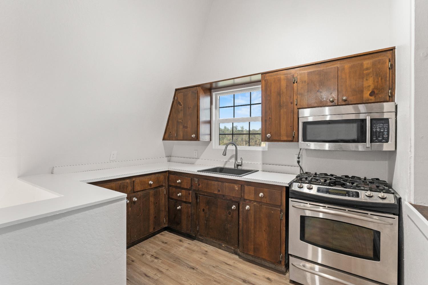 5585 Garden Bar Road, Unit 2 Lincoln, CA 95648 - Photo 10 of 65 a kitchen with stainless steel appliances a stove sink and cabinets