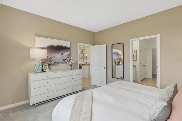 a spacious bedroom with a bed and a mirror