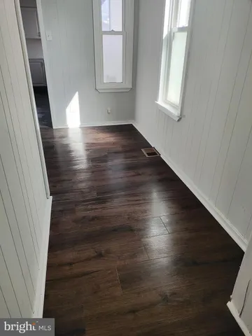 a view of wooden floor and windows in a room