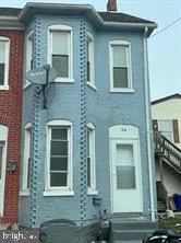 a view of a brick house with many windows