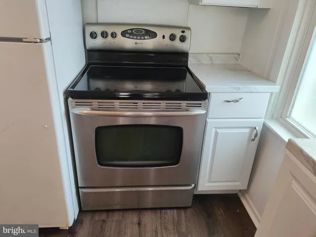 a stove top oven sitting inside of a kitchen