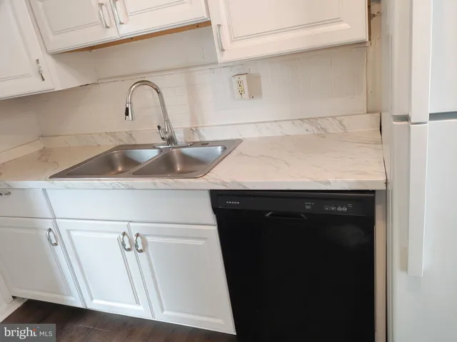 a kitchen with a sink and a refrigerator