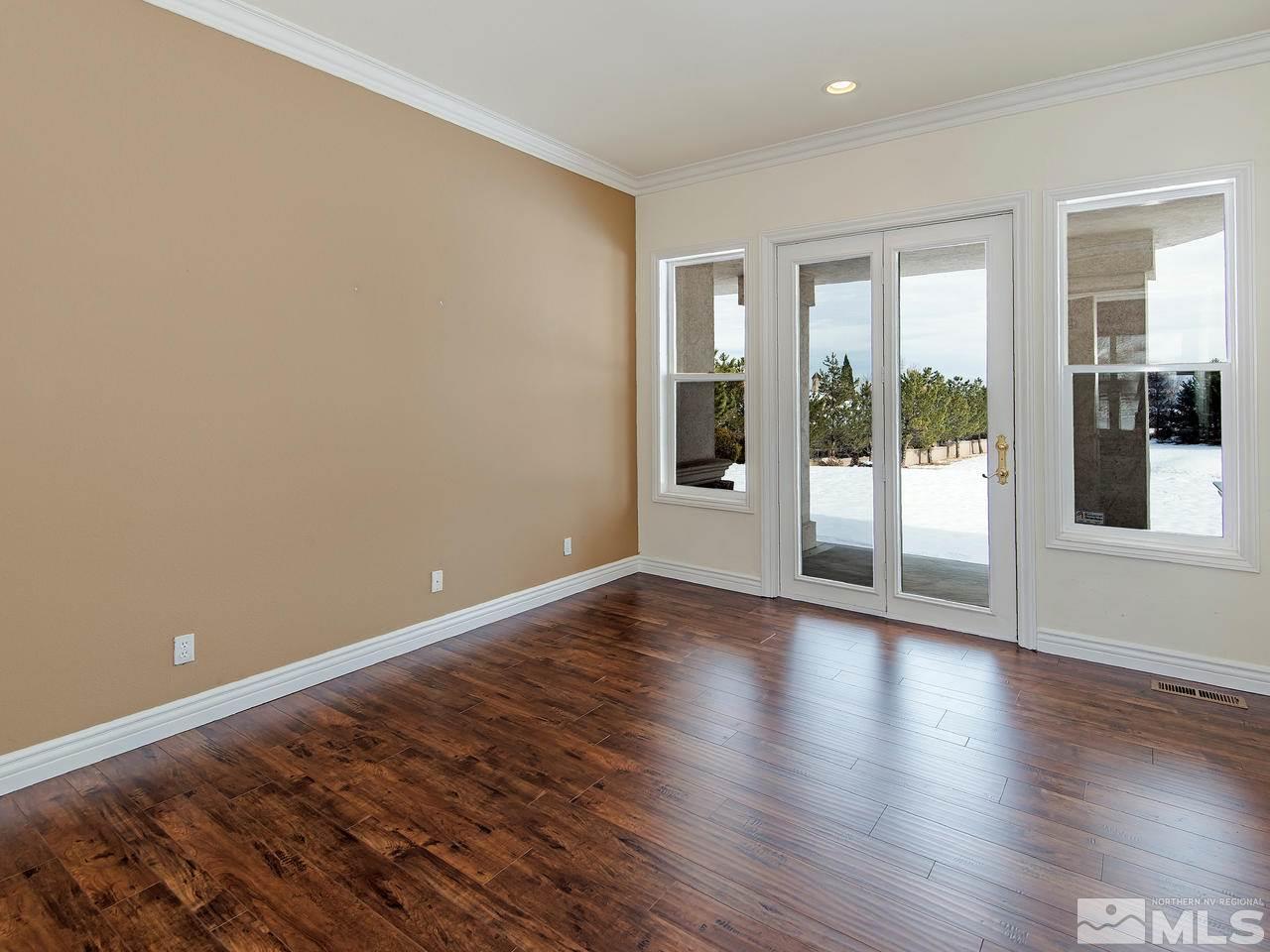 4195 Basque Lane Reno, NV 89519 - Photo 15 of 24 a view of an empty room with wooden floor and a window