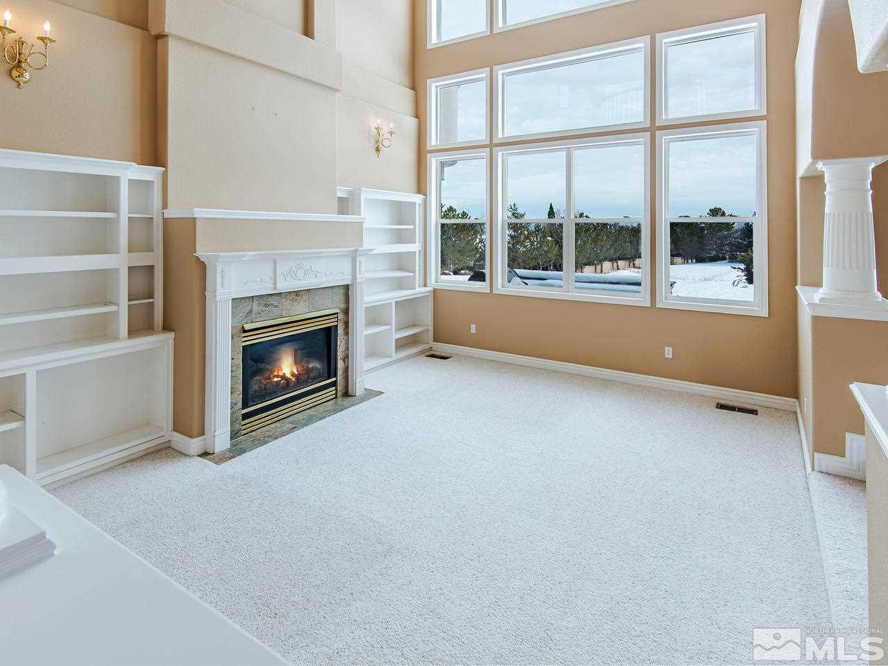 4195 Basque Lane Reno, NV 89519 - Photo 6 of 24 a view of an empty room with a fireplace and a window