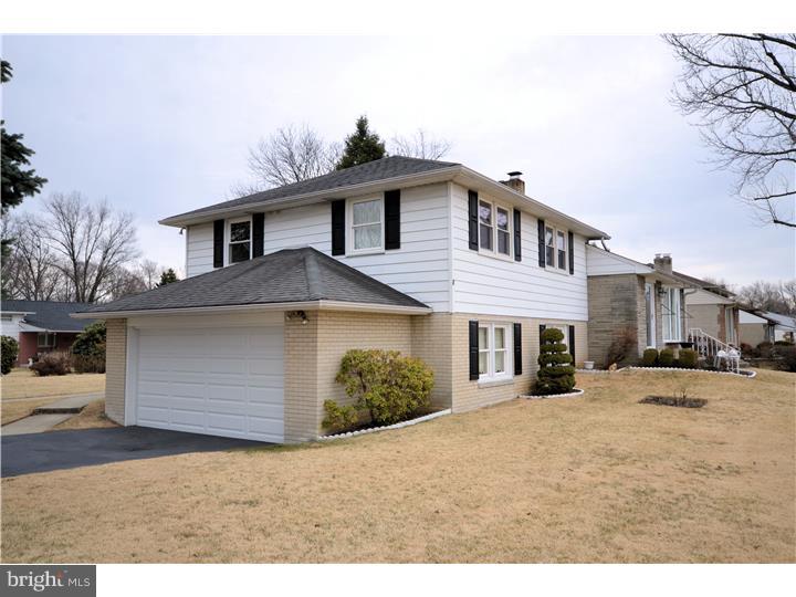 1001 Susan Road Philadelphia, PA 19115 - Photo 2 of 25 a front view of a house with a yard and garage