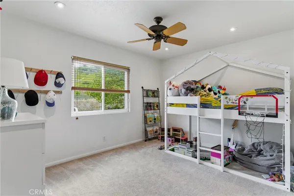 a view of play room with toys and a chandelier