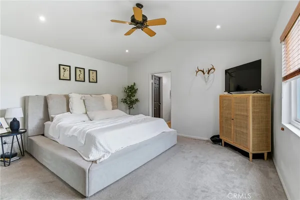 a bedroom with a bed and a television