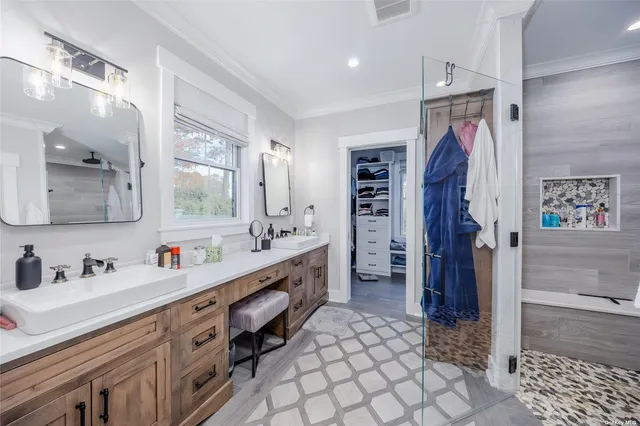a bathroom with a double vanity sink mirror and shower