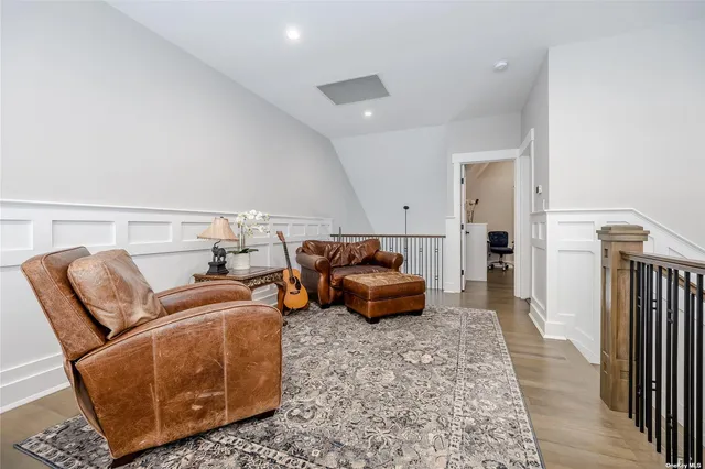 a bedroom with furniture and wooden floor