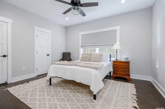 a bedroom with a bed and painting on the wall