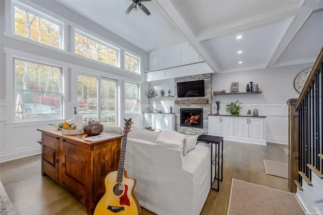 a living room with furniture a flat screen tv and a fireplace